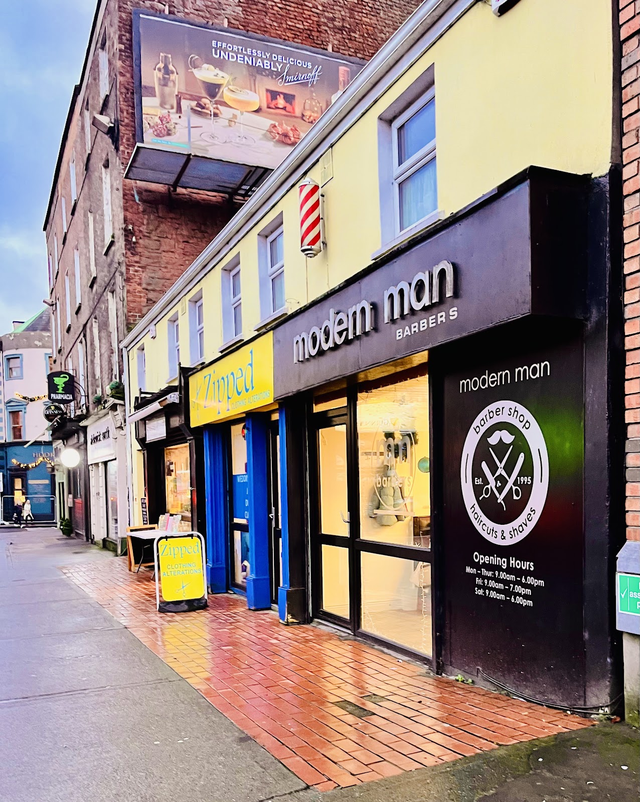 The Modern Man Barbers shopfront on Sarsfield Street, Limerick, with Est. 1995 signage and hours on the window